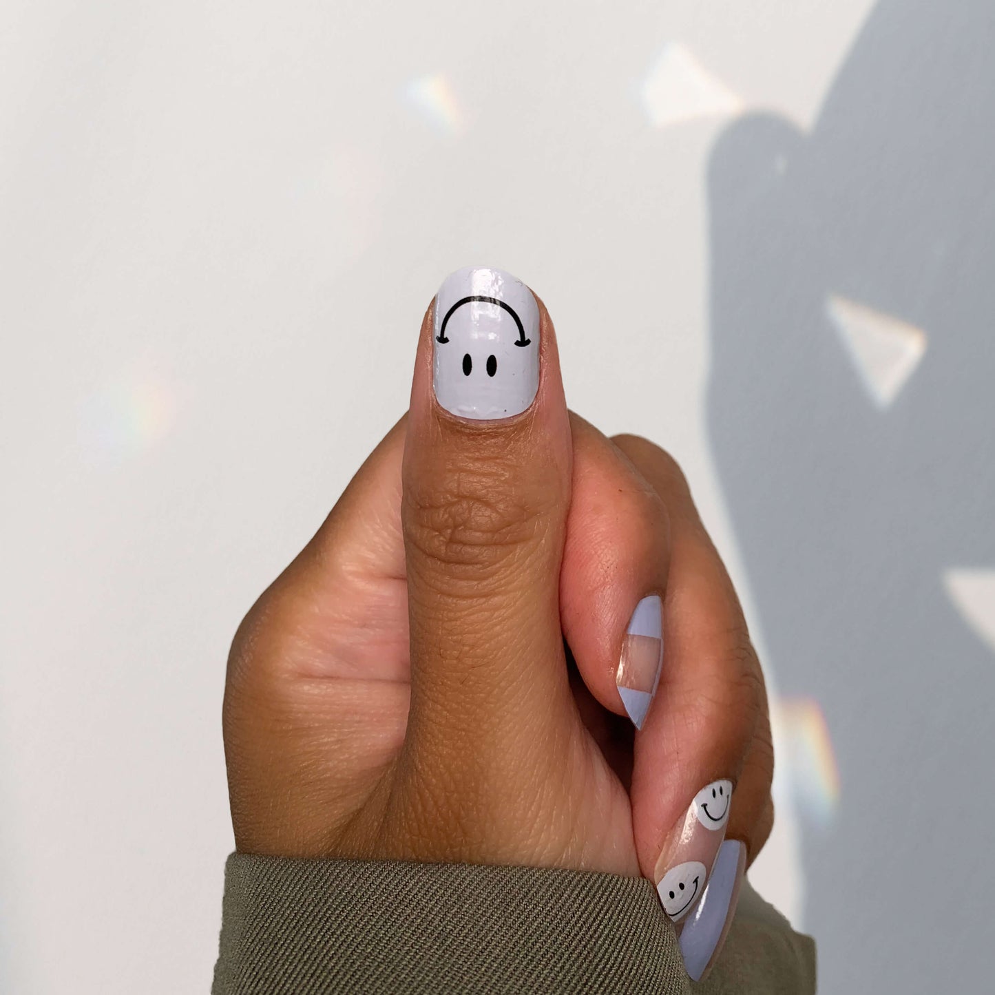 Smiley design nail stickers on thumb